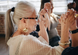 Woman in a group clasping hands in support