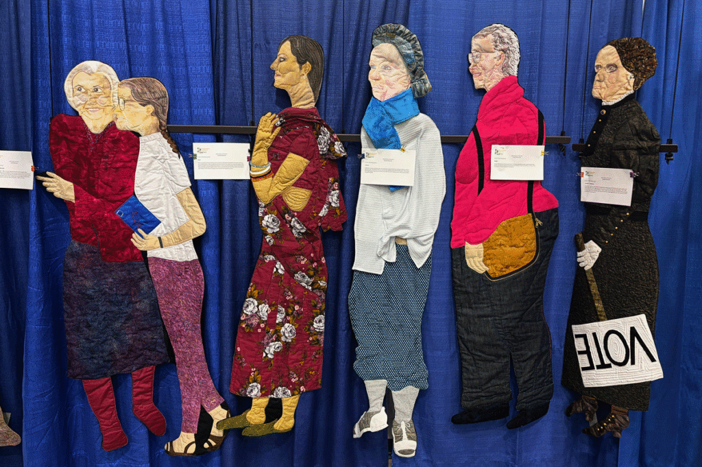 Quilted images of people standing in line to vote
